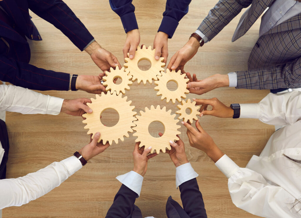 hands in a circle with gears
