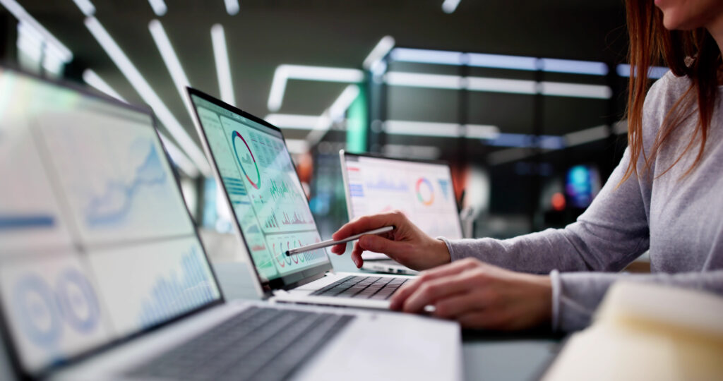 Young woman analyzing business KPI data on computer screen.
