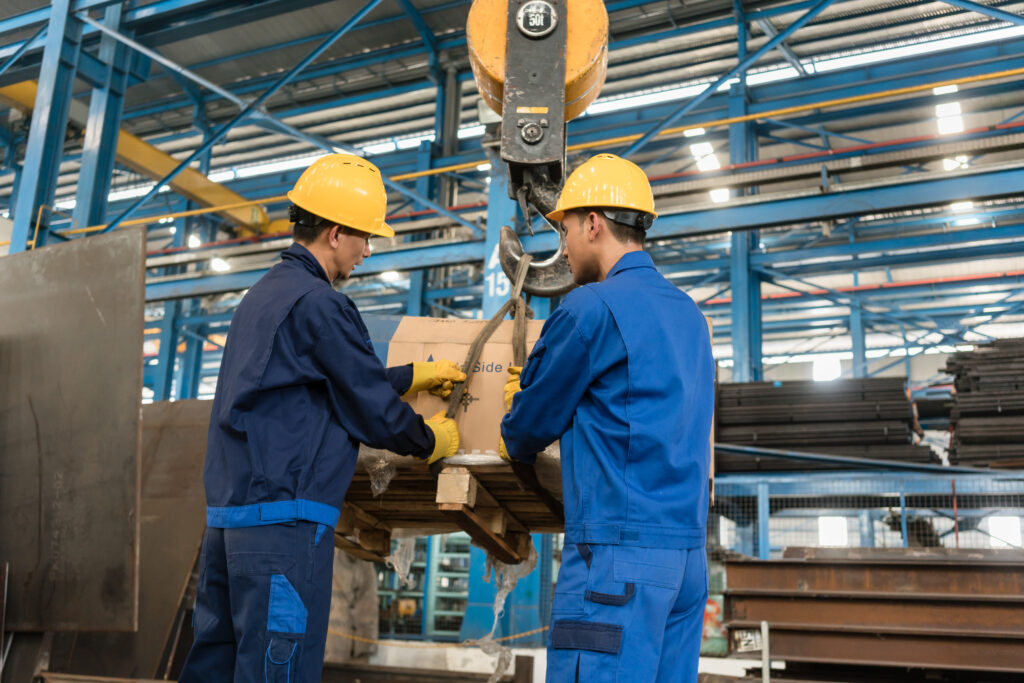 Two men in a warehouse handling a package