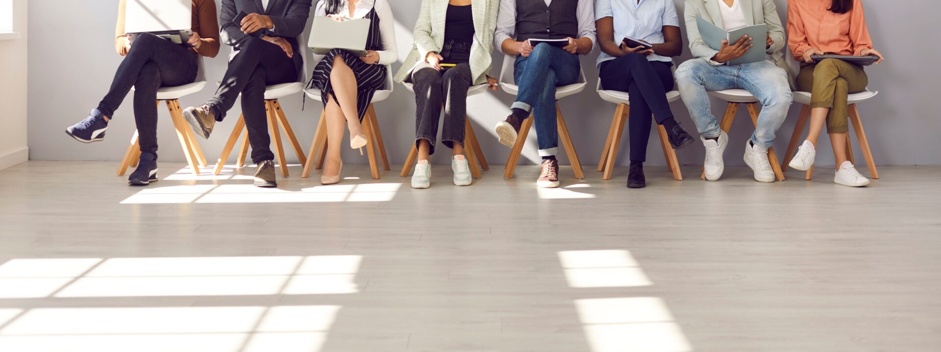 Diverse group seated in a waiting area.
