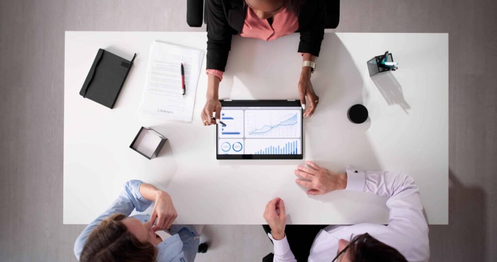 Team analyzing data on a tablet together.