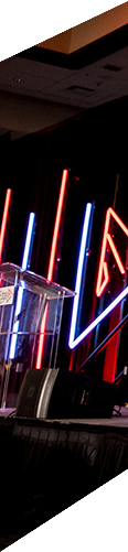 Stage with colorful neon lights and a podium.