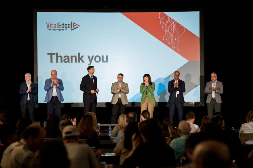 Speakers on stage thanking the audience.