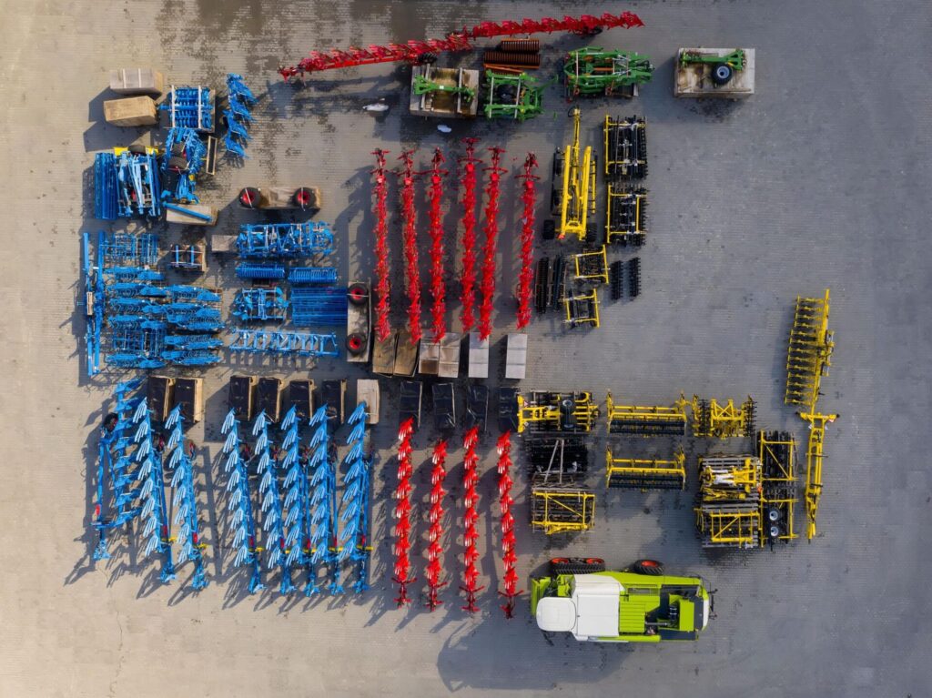 Aerial view of colorful farming equipment arranged neatly.