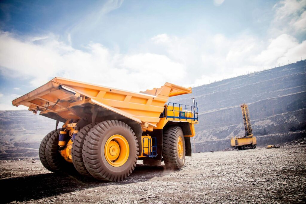 Large yellow mining dump truck on quarry site.