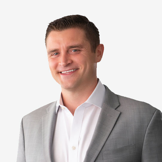 Smiling man in a gray suit against white background