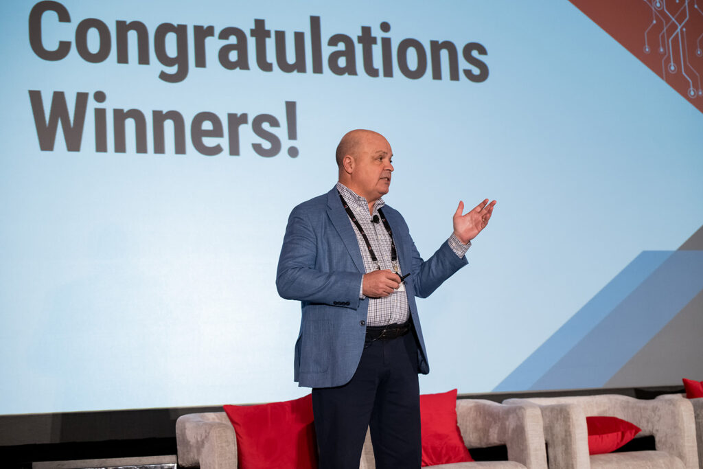 Speaker announces winners at a conference.